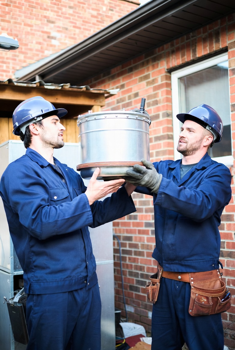 Certified HVAC technicians installing furnaces with precision to ensure safe, effective, and reliable home heating